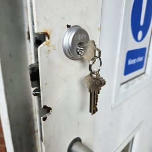 Close up of new lock being fitted into an office building