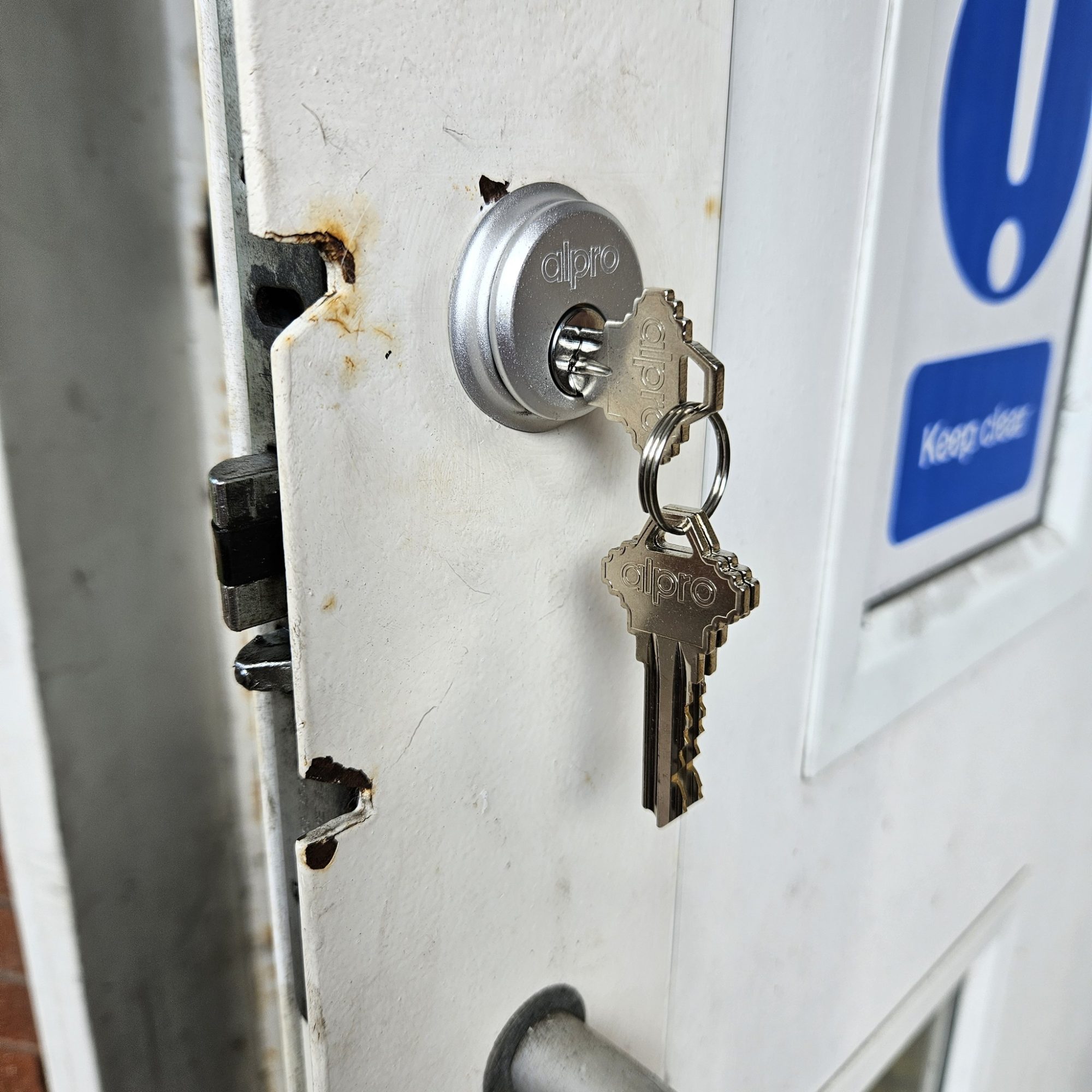 Close up of new lock being fitted into an office building